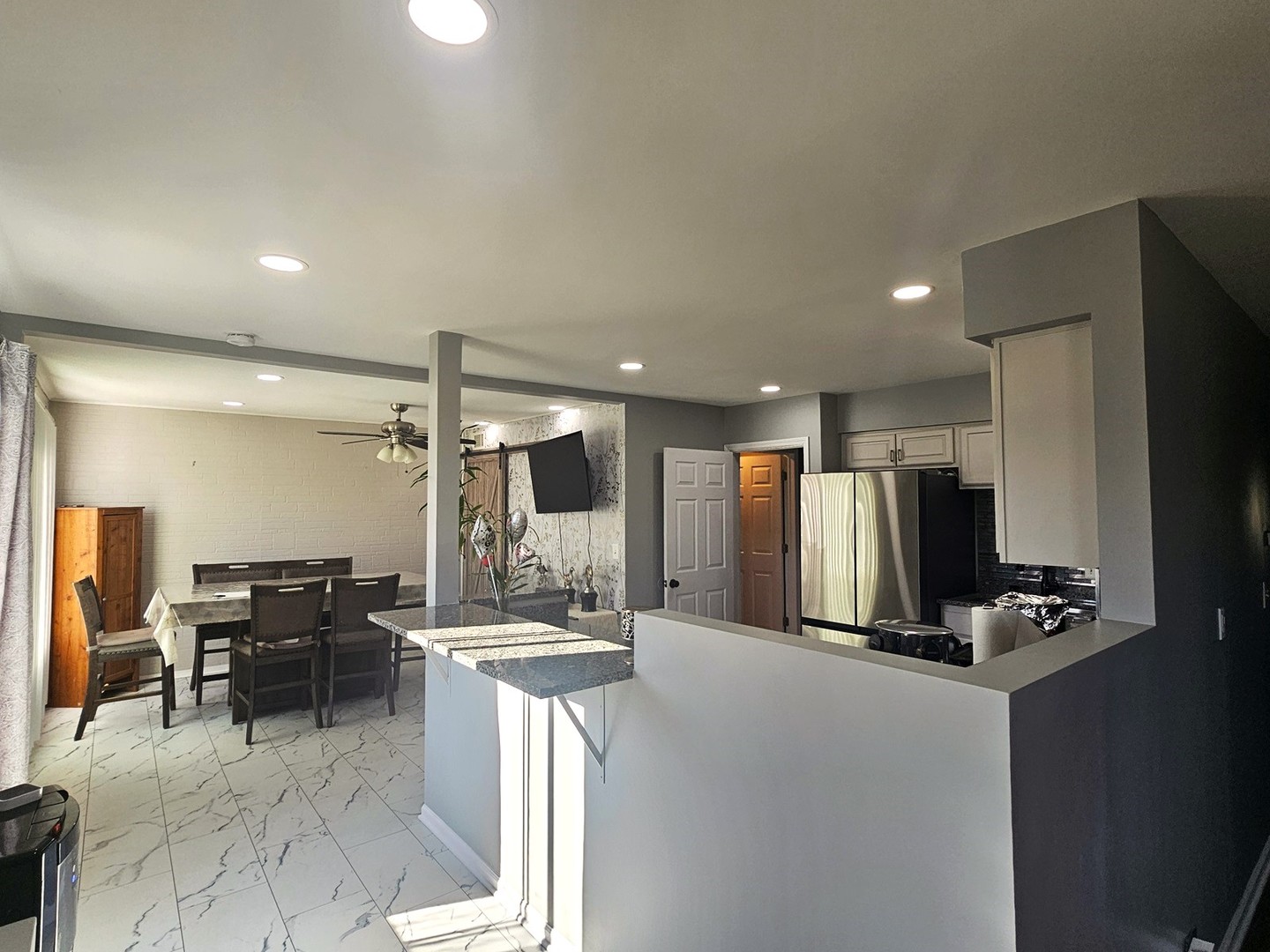 1353 Spring Valley Drive Carol Stream, IL 60188 - Photo 4 of 25 a kitchen with stainless steel appliances kitchen island granite countertop a refrigerator and a sink