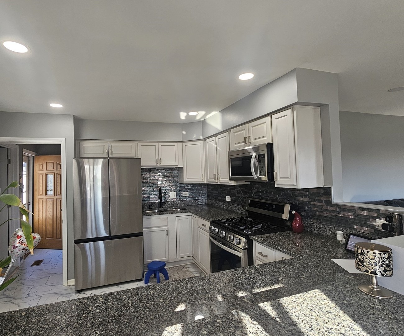 1353 Spring Valley Drive Carol Stream, IL 60188 - Photo 5 of 25 a kitchen with stainless steel appliances granite countertop a refrigerator stove microwave and sink
