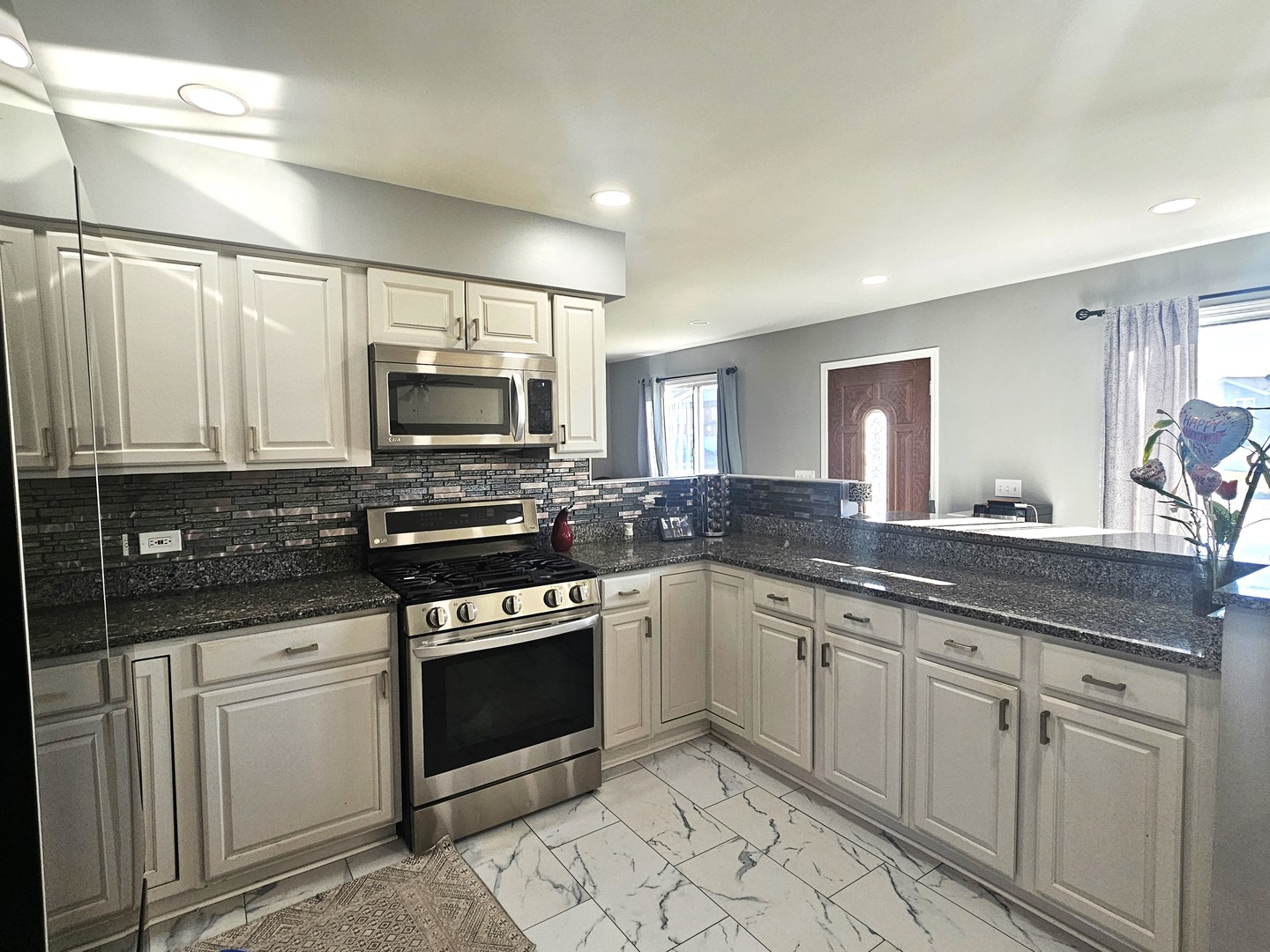 1353 Spring Valley Drive Carol Stream, IL 60188 - Photo 7 of 25 a kitchen with a sink stove and microwave