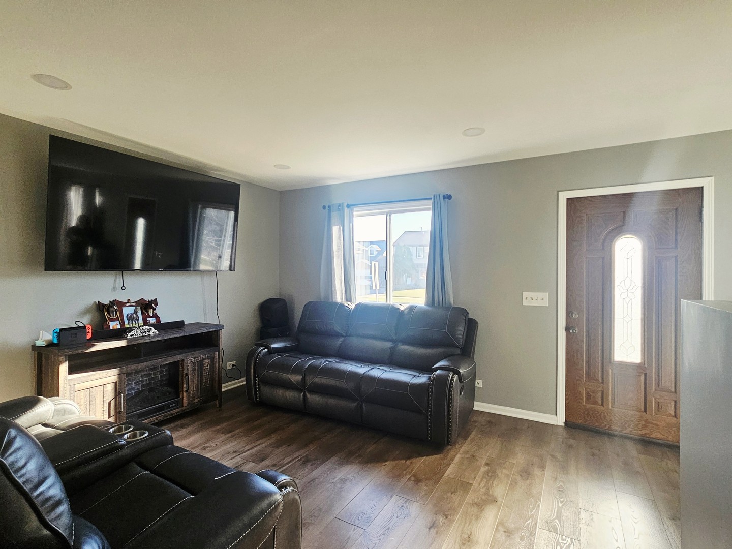 1353 Spring Valley Drive Carol Stream, IL 60188 - Photo 10 of 25 a living room with furniture and a flat screen tv