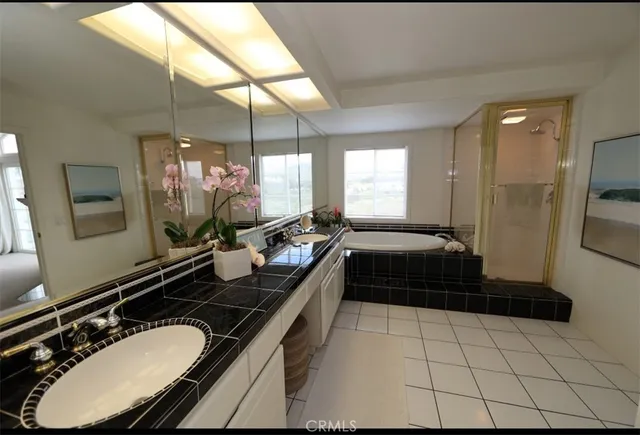 a bathroom with a double vanity sink and a mirror