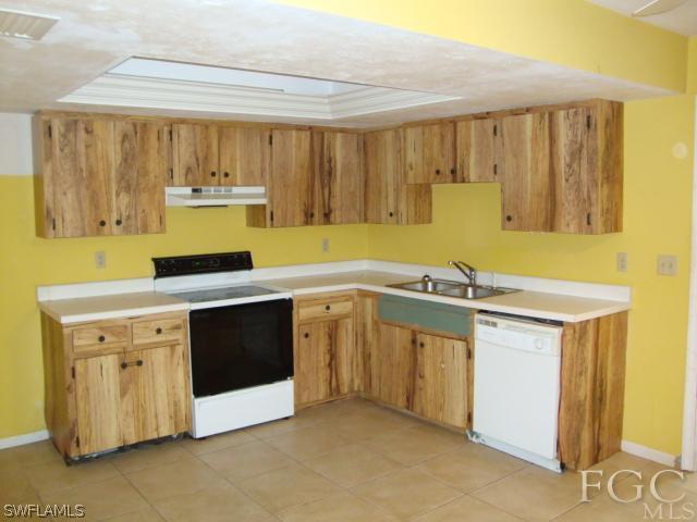 19055 Evergreen Road Fort Myers, FL 33967 - Photo 3 of 9 a kitchen with a stove and a sink