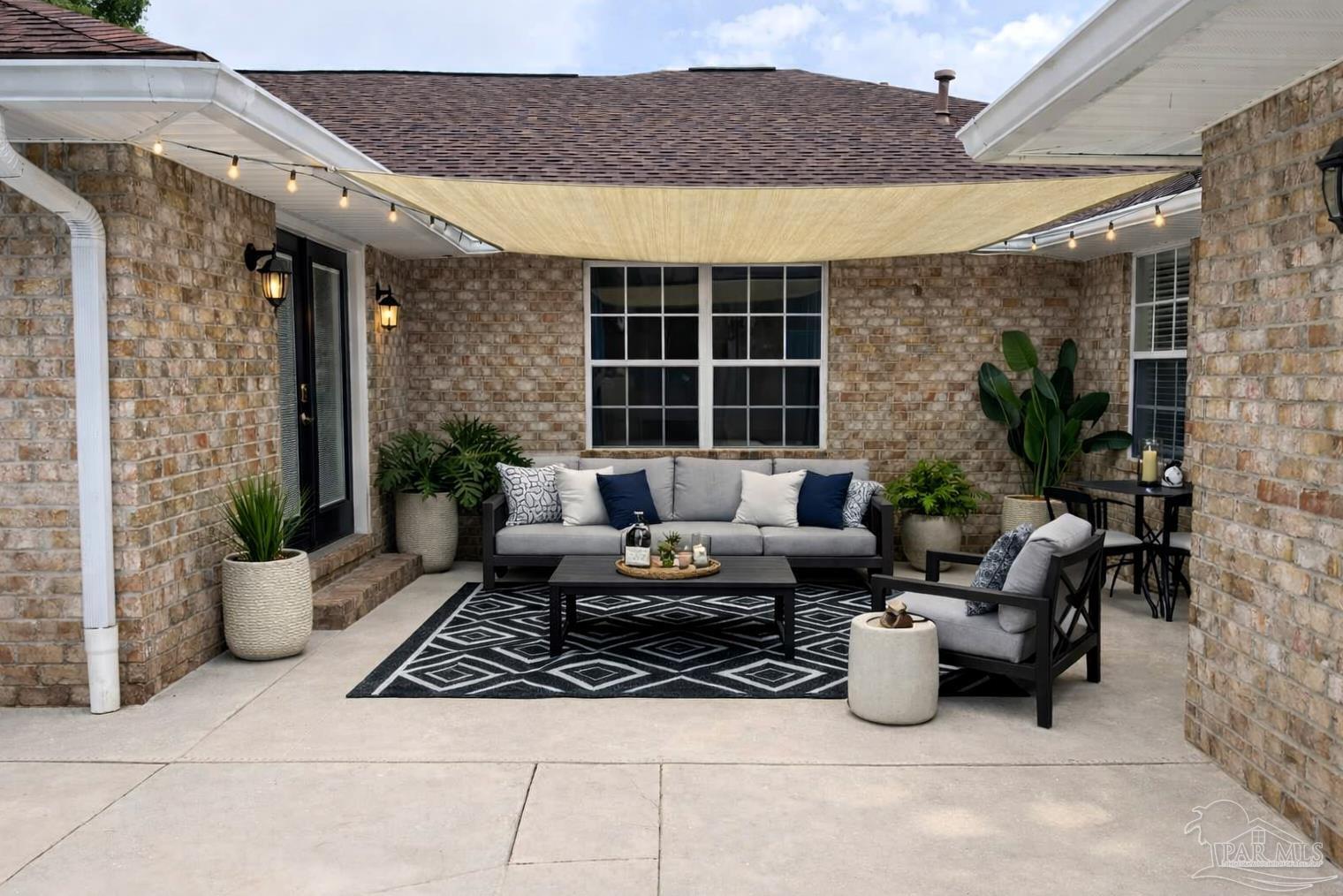 3055 Wallace Lake Road Pace, FL 32571 - Photo 26 of 33 a outdoor living space with furniture and a potted plant