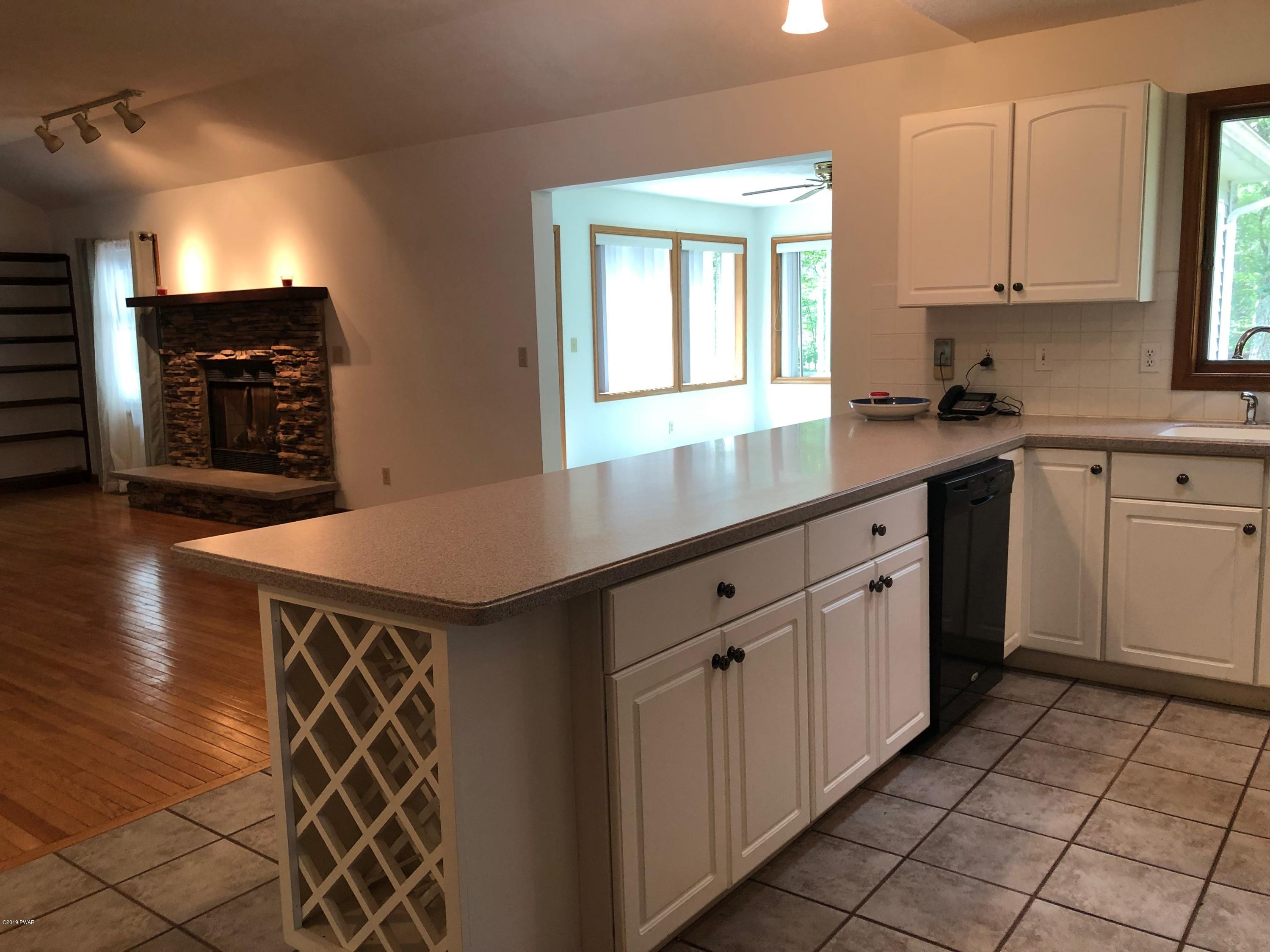 213 Maple Ridge Drive Hawley, PA 18428 - Photo 13 of 44 a kitchen with a sink window and cabinets