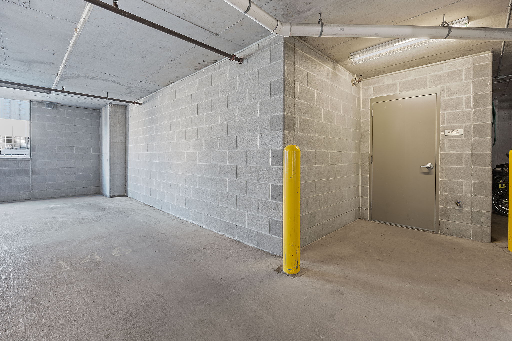 360 Nueces Street, Unit 1007 Austin, TX 78701 - Photo 30 of 40 Garage with concrete block wall