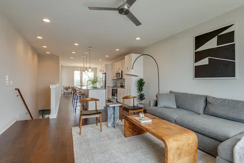 a bedroom with a large bed a chandelier and a window