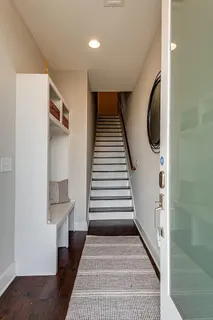 a kitchen with stainless steel appliances granite countertop a sink a stove and a wooden floors