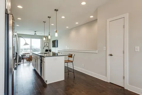 a kitchen with stainless steel appliances granite countertop a sink a microwave and cabinets