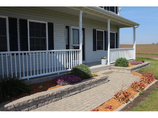 11897 Smith Road Pecatonica, IL 61063 - Photo 1 of 11 a view of a house that has a small yard and wooden floor