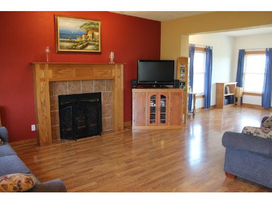 11897 Smith Road Pecatonica, IL 61063 - Photo 2 of 11 a living room with furniture a flat screen tv and a fireplace