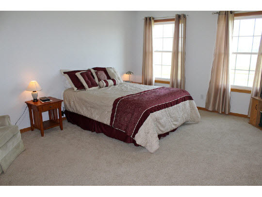 11897 Smith Road Pecatonica, IL 61063 - Photo 6 of 11 a spacious bedroom with a bed and a window