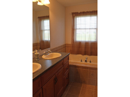 11897 Smith Road Pecatonica, IL 61063 - Photo 7 of 11 a bathroom with a sink double vanity and a mirror