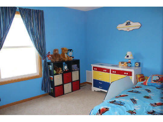 11897 Smith Road Pecatonica, IL 61063 - Photo 8 of 11 a bedroom with a bed and a window