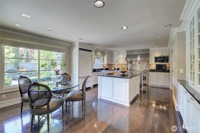 a kitchen with stainless steel appliances granite countertop a sink a stove and cabinets