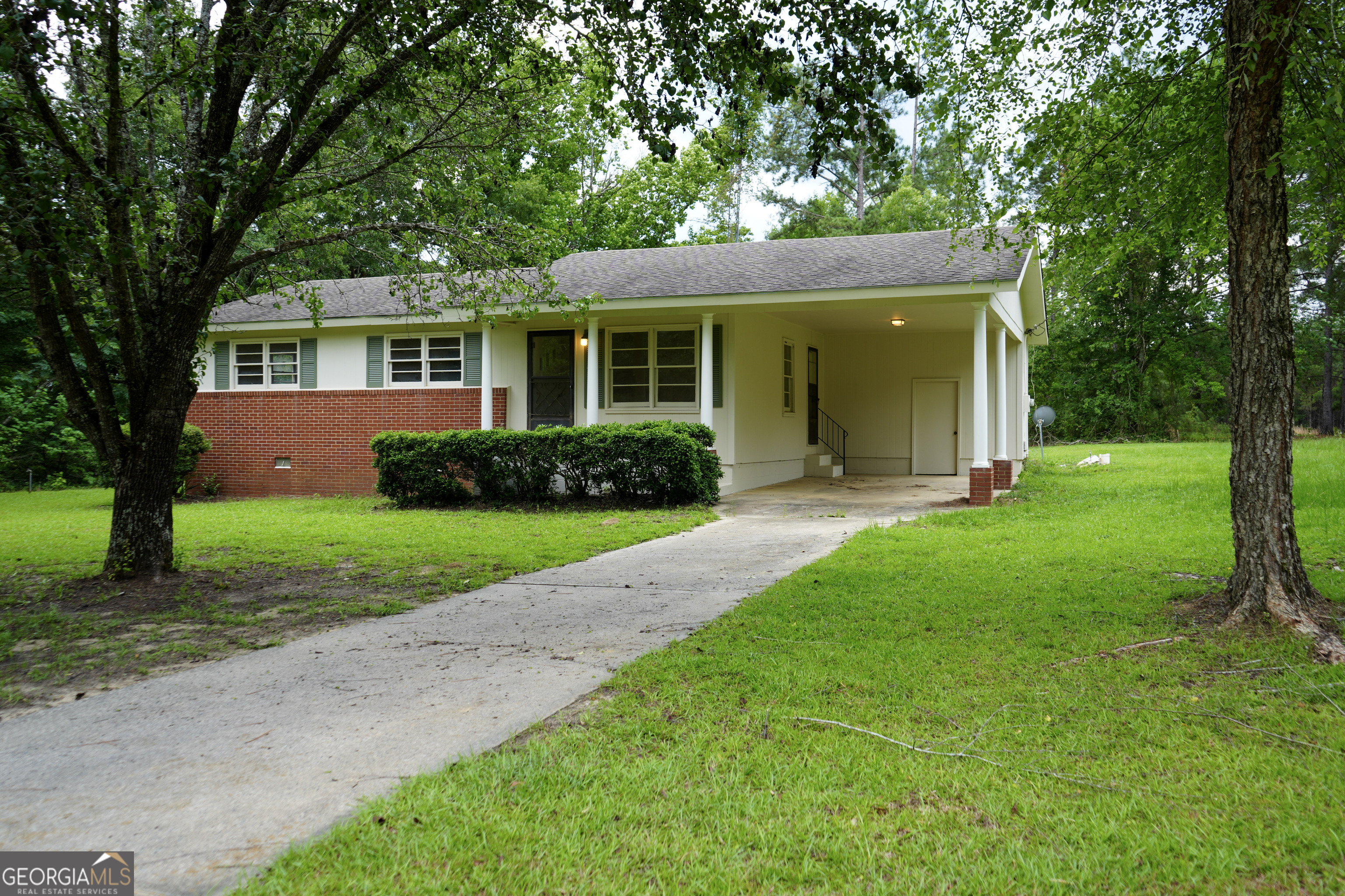 1869 Minter Blue Springs Road Rockledge, GA 30454 - Photo 11 of 45 a view of a house with a yard and potted plants