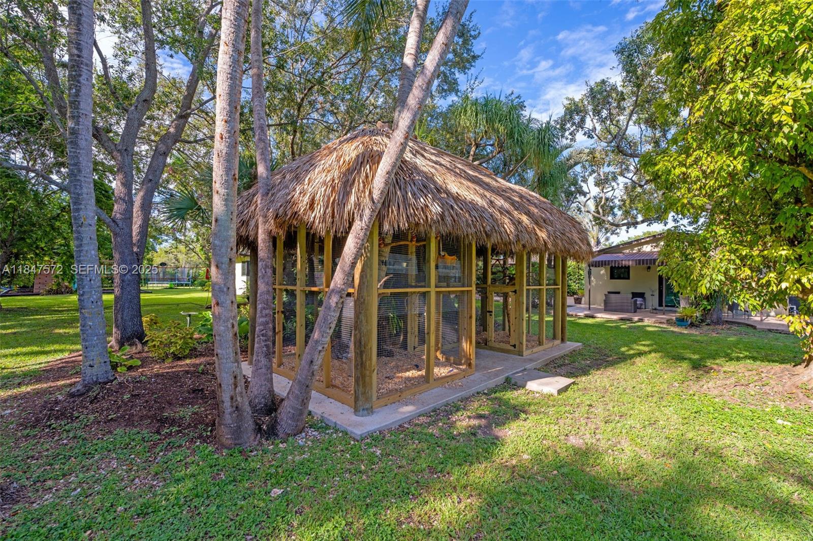 18200 Southwest 296th Street Homestead, FL 33030 - Photo 30 of 55 a view of a house with backyard and a tree