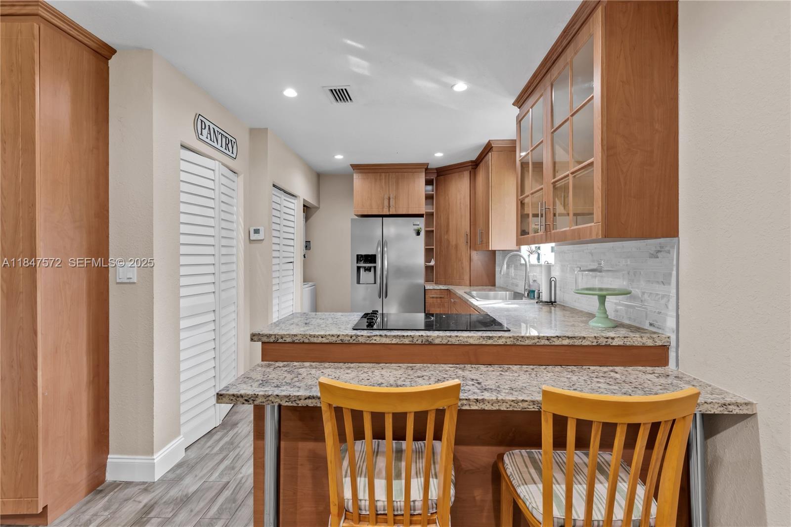 18200 Southwest 296th Street Homestead, FL 33030 - Photo 38 of 55 a kitchen with stainless steel appliances granite countertop a stove a sink and a refrigerator