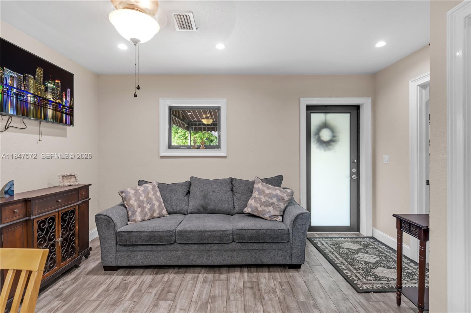 18200 Southwest 296th Street Homestead, FL 33030 - Photo 40 of 55 a living room with furniture and a fireplace