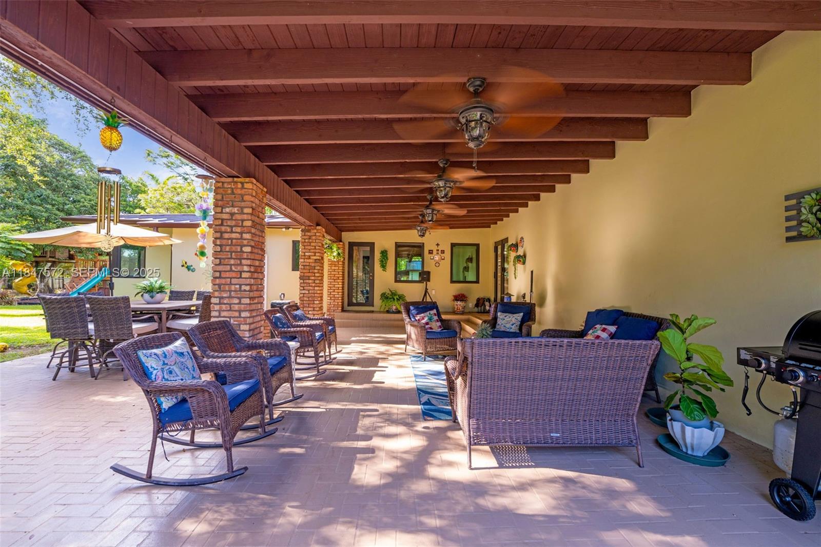 18200 Southwest 296th Street Homestead, FL 33030 - Photo 4 of 55 a living room with patio furniture and a potted plant