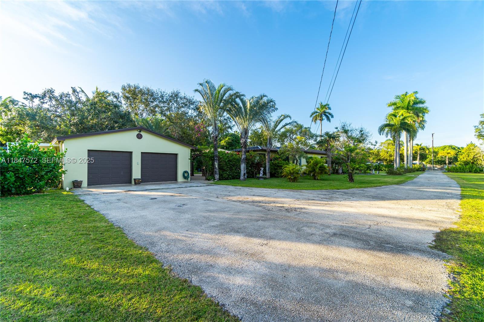 18200 Southwest 296th Street Homestead, FL 33030 - Photo 49 of 55 a front view of a house with a yard and garage