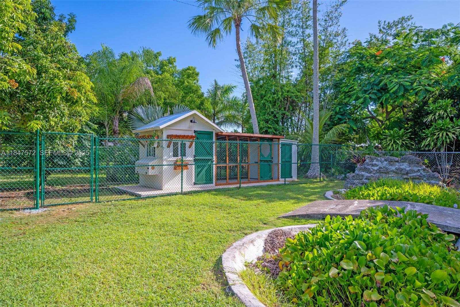 18200 Southwest 296th Street Homestead, FL 33030 - Photo 7 of 55 a view of a house with a yard and sitting area