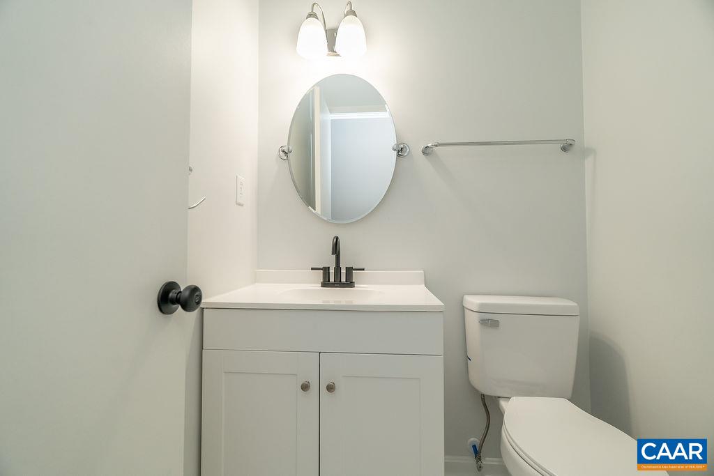 2087 Commonwealth Drive Charlottesville, VA 22901 - Photo 12 of 44 a bathroom with a toilet a sink and mirror