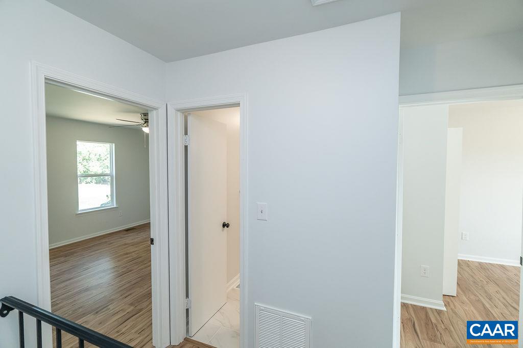 2087 Commonwealth Drive Charlottesville, VA 22901 - Photo 16 of 44 a view of a hallway with wooden floor and closet