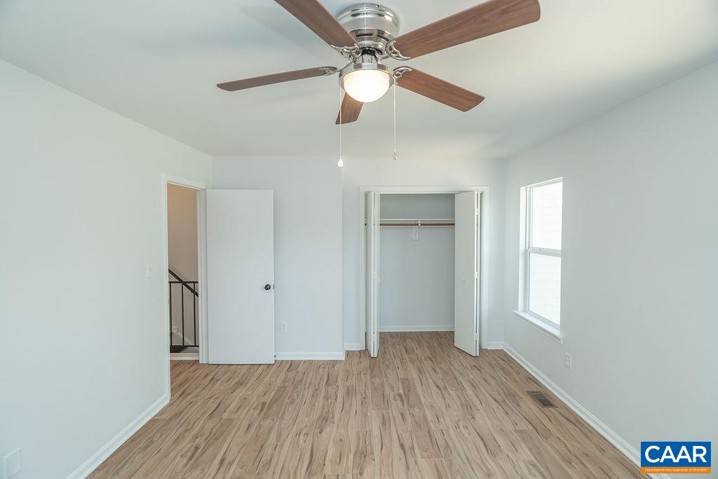 2087 Commonwealth Drive Charlottesville, VA 22901 - Photo 19 of 44 wooden floor in an empty room with a window