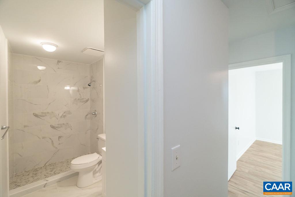 2087 Commonwealth Drive Charlottesville, VA 22901 - Photo 20 of 44 a bathroom with a granite countertop toilet and a shower
