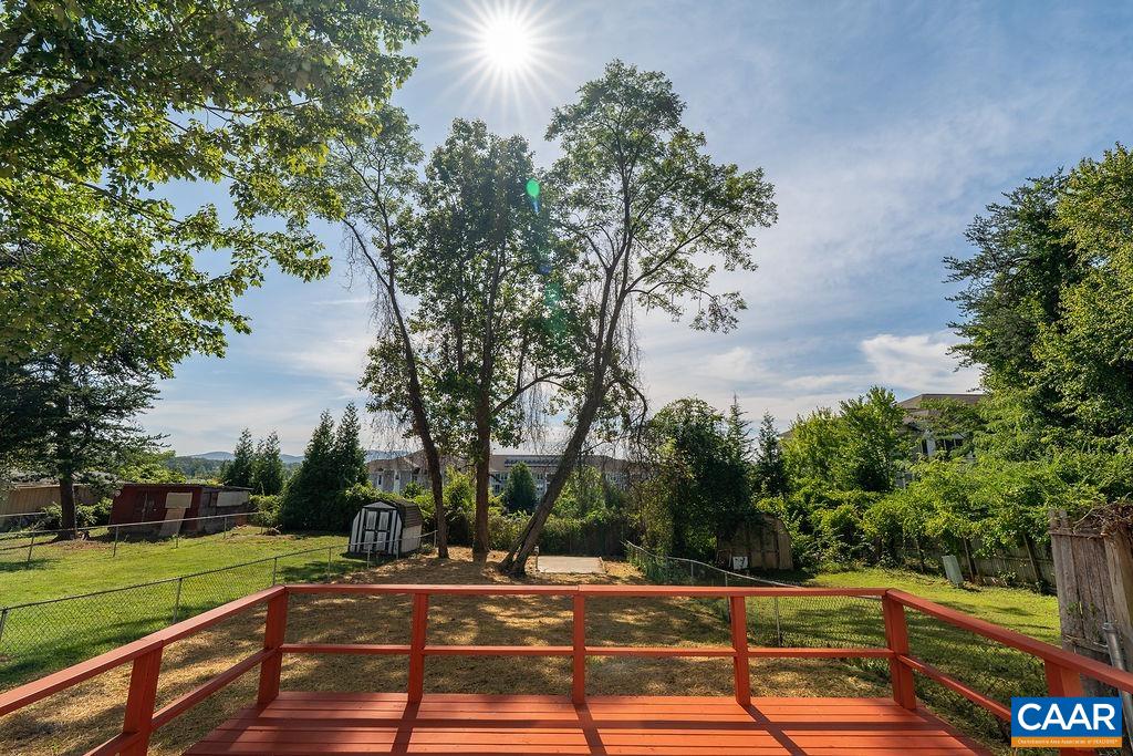 2087 Commonwealth Drive Charlottesville, VA 22901 - Photo 30 of 44 a view of a yard with flower plants and large trees
