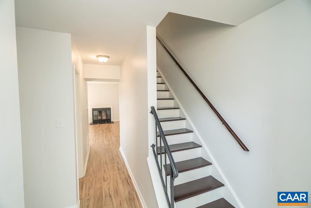 2087 Commonwealth Drive Charlottesville, VA 22901 - Photo 5 of 44 a view of a hallway with wooden floor and staircase