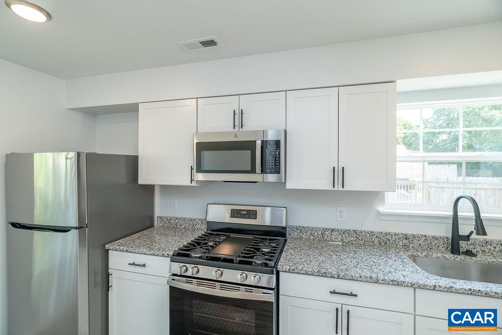 2087 Commonwealth Drive Charlottesville, VA 22901 - Photo 6 of 44 a kitchen with stainless steel appliances granite countertop white cabinets granite counter tops and a window