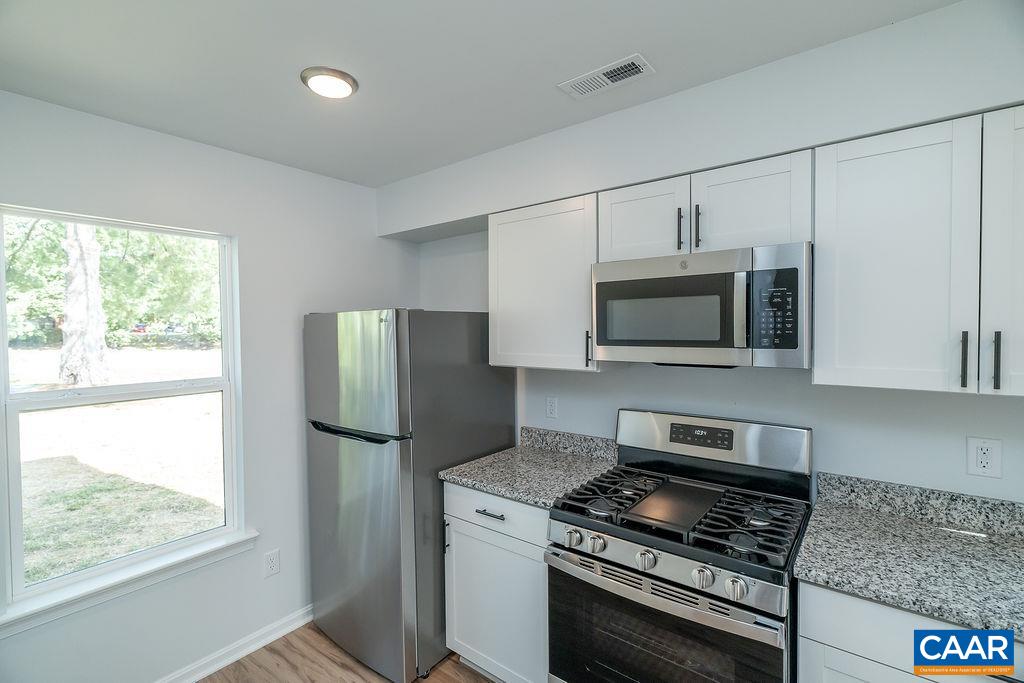2087 Commonwealth Drive Charlottesville, VA 22901 - Photo 7 of 44 a kitchen with stainless steel appliances granite countertop a stove a microwave and a refrigerator