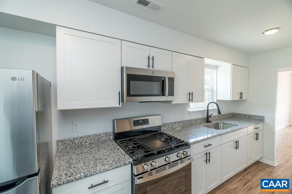 2087 Commonwealth Drive Charlottesville, VA 22901 - Photo 8 of 44 a kitchen with stainless steel appliances granite countertop a sink stove and refrigerator