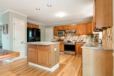 a kitchen with stainless steel appliances a stove sink and cabinets