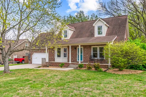 a front view of house with yard and outdoor seating