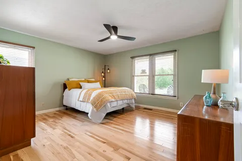 a bedroom with a bed and a window