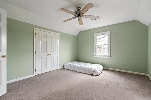 a living room with a bed furniture and a window