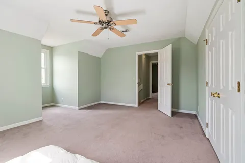 a view of an empty room with a ceiling fan
