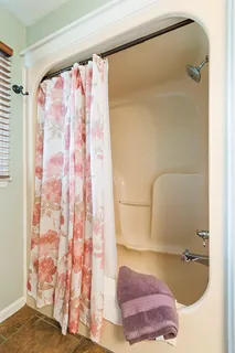 a bathroom with a bathtub and shower