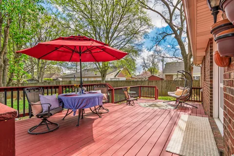 a view of a balcony with wooden floor and outdoor seating