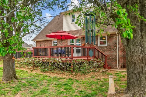 a view of a house with a yard and sitting area