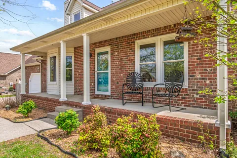 a front view of a house with outdoor seating