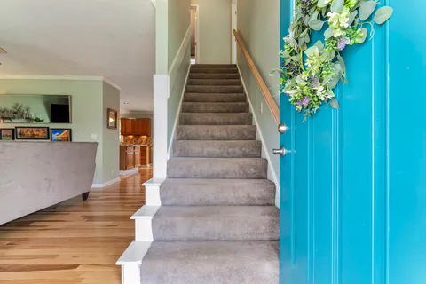 a view of entryway and hall with wooden floor
