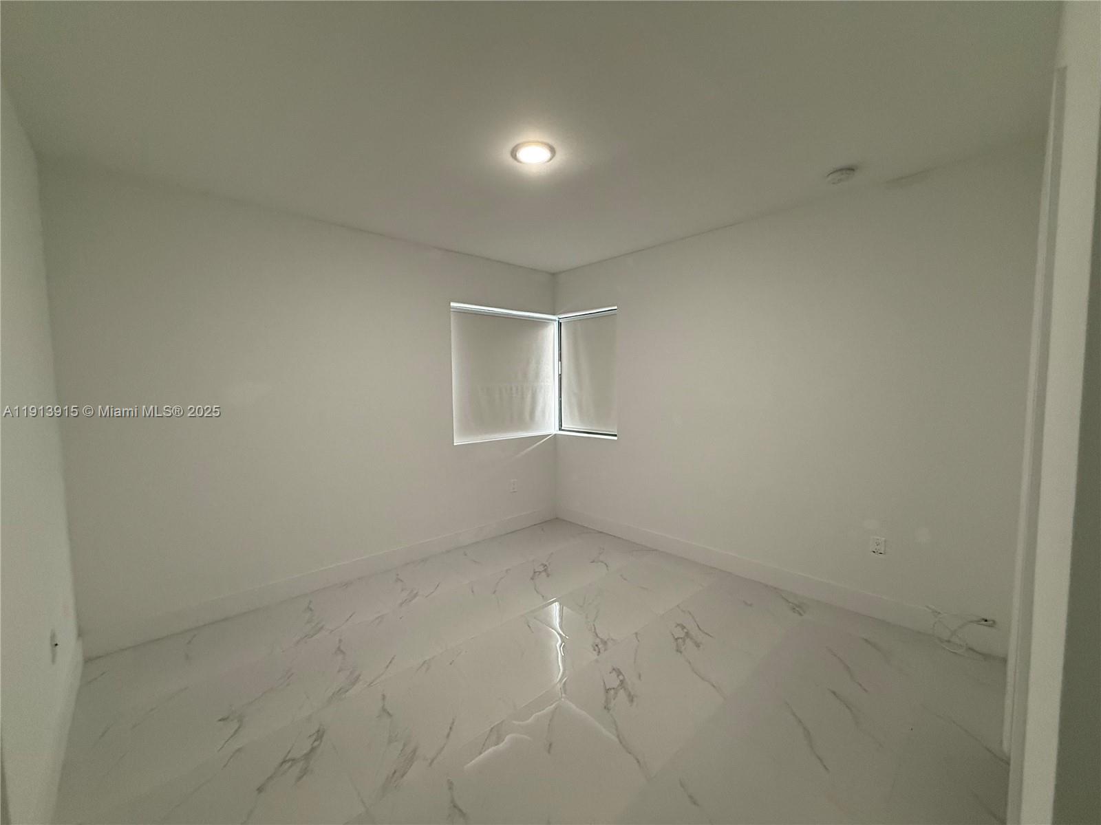 450 Beacom Boulevard, Unit B Miami, FL 33135 - Photo 11 of 11 an empty room with windows and closet