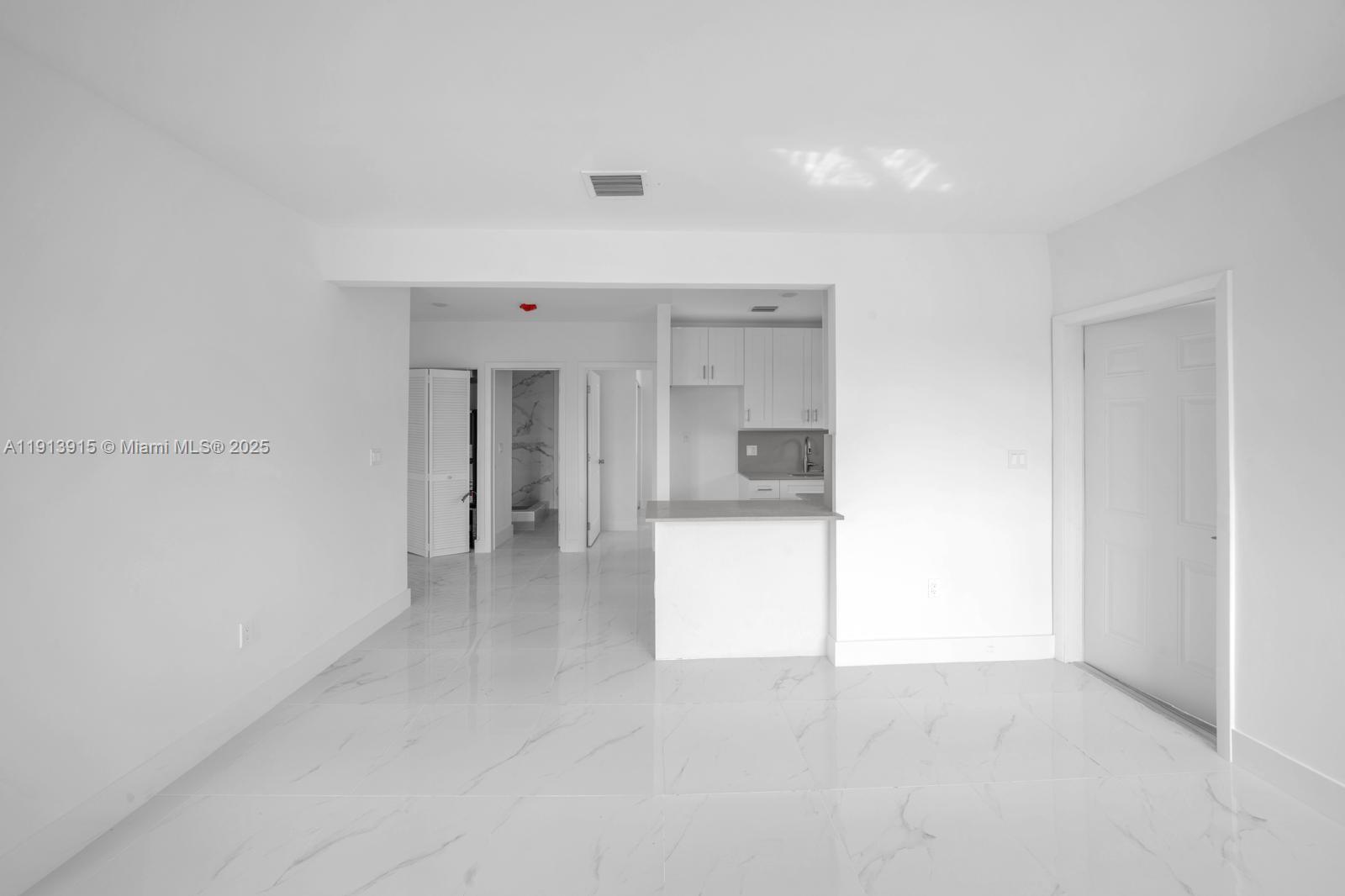 450 Beacom Boulevard, Unit B Miami, FL 33135 - Photo 4 of 11 a view of a hallway with a kitchen
