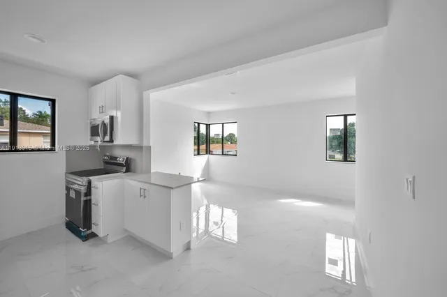 a kitchen with cabinets and window