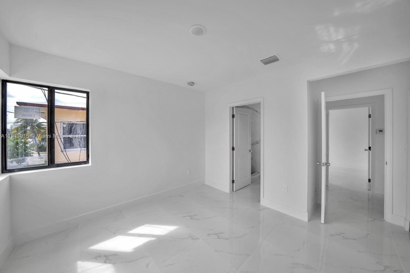 450 Beacom Boulevard, Unit B Miami, FL 33135 - Photo 8 of 11 a view of an empty room with a window