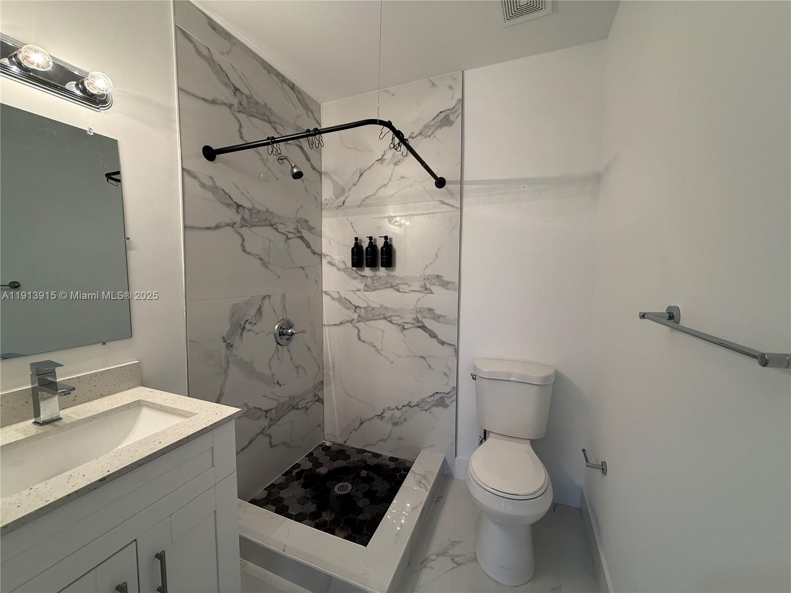 450 Beacom Boulevard, Unit B Miami, FL 33135 - Photo 10 of 11 a bathroom with a sink toilet and shower
