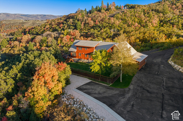 5878 Snowbasin Road Huntsville, UT 84317 - Photo 68 of 90 Red-sided residence with a gray metal roof, surrounded by mature trees